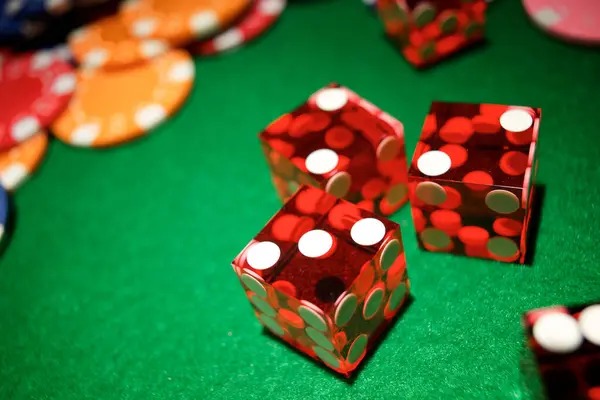 Overhead view of a roulette wheel and betting table with chips placed on various numbers